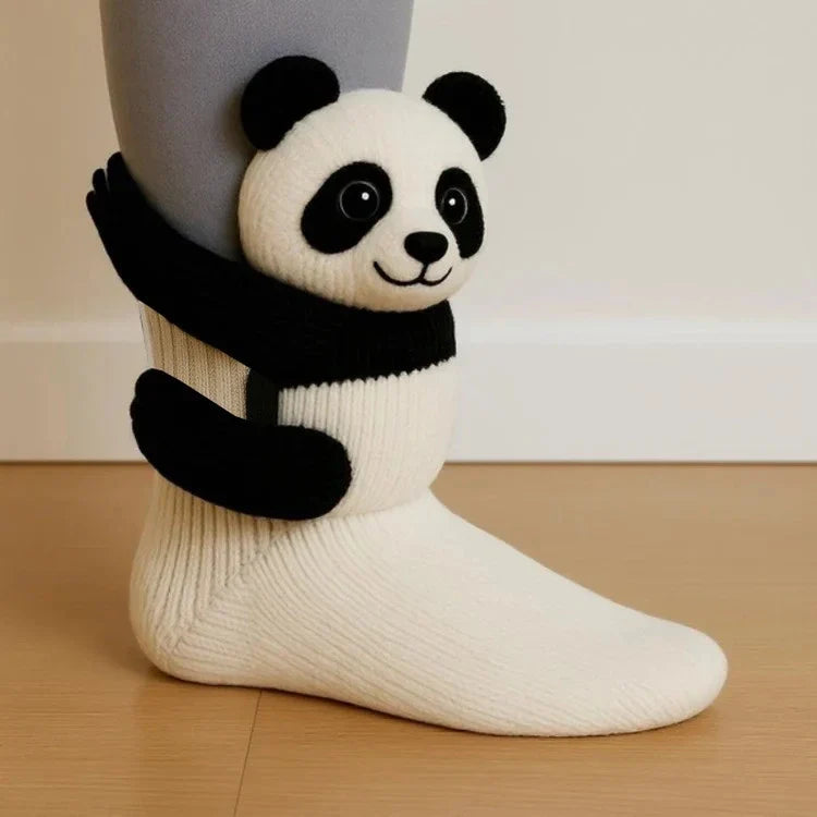 White sock with a panda design on a wooden floor.